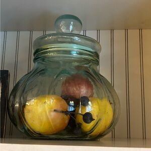 Vintage green glass fruit jar with fake fruit included.. small crack on lid